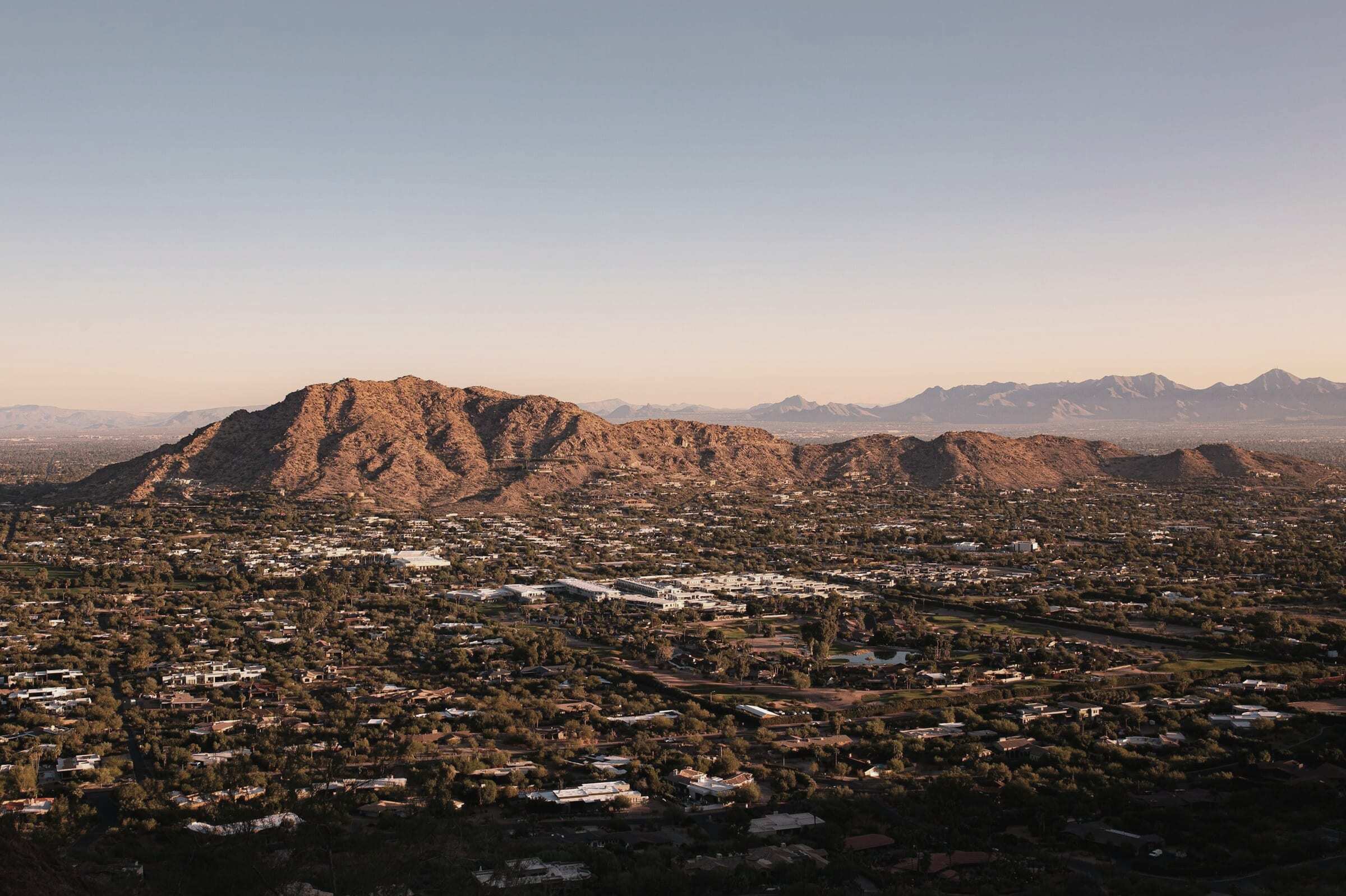 Camelback Mountain in low evening sun above the spread-out low-rise city of Scottsdale, Arizona
