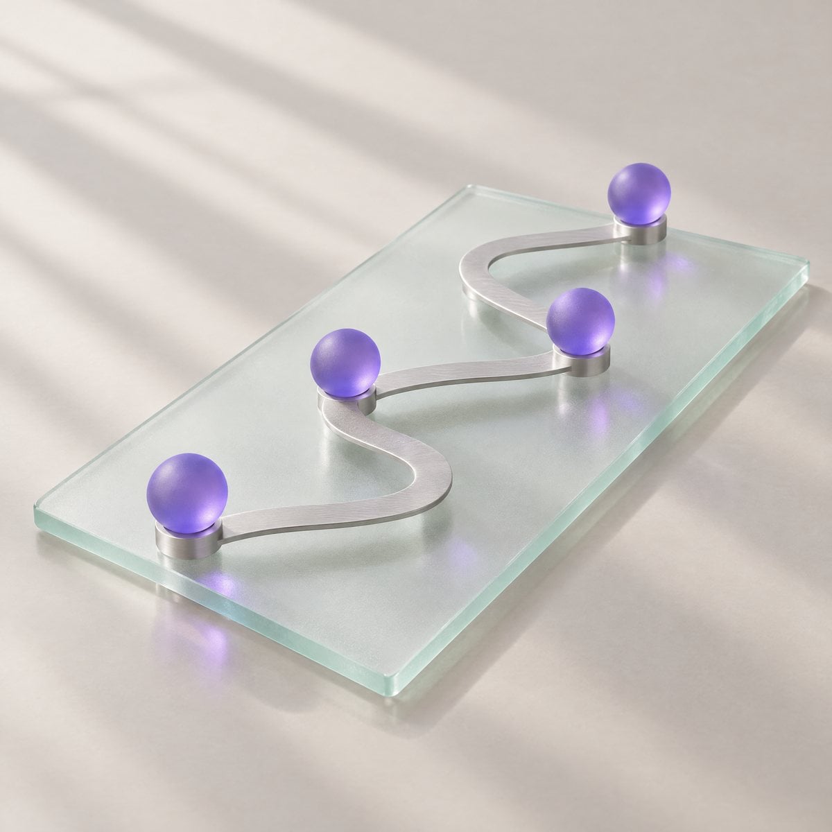 A glass tablet with an aluminum path connecting four violet spheres, like a roadmap